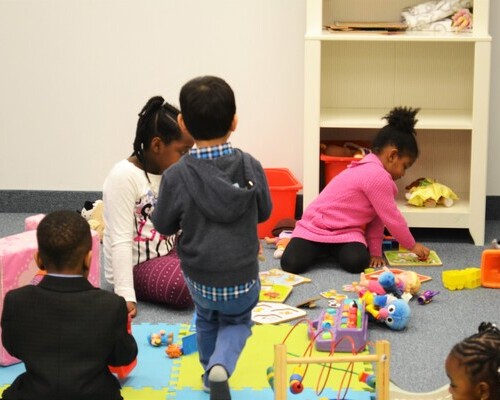 A group of young children playing with toys