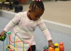 A little girl playing with toys