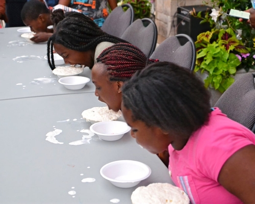 Four kids having an eating contest