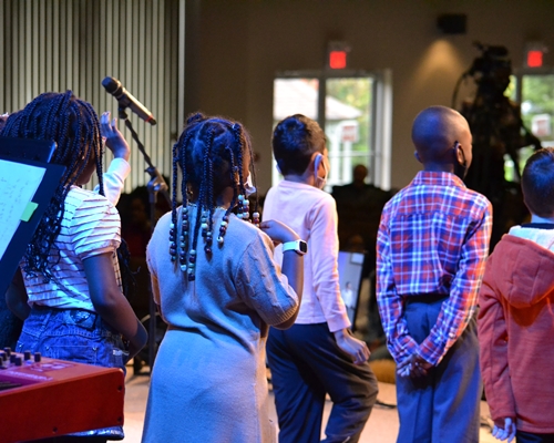 A group of children standing on stage