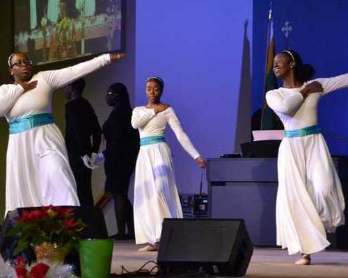 Ladies dancing with one hand reaching out and the other hand rested on chest