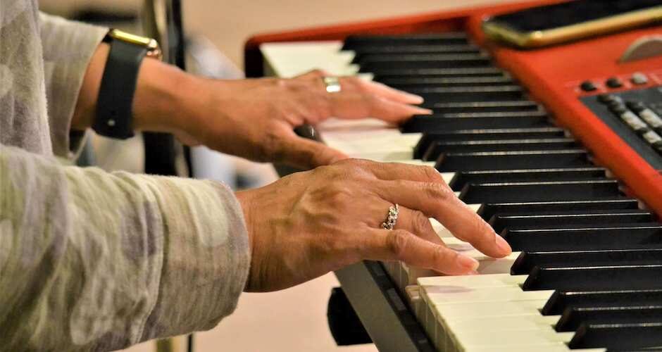 Hands playing the piano