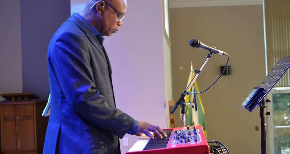 Man standing and playing the keyboard